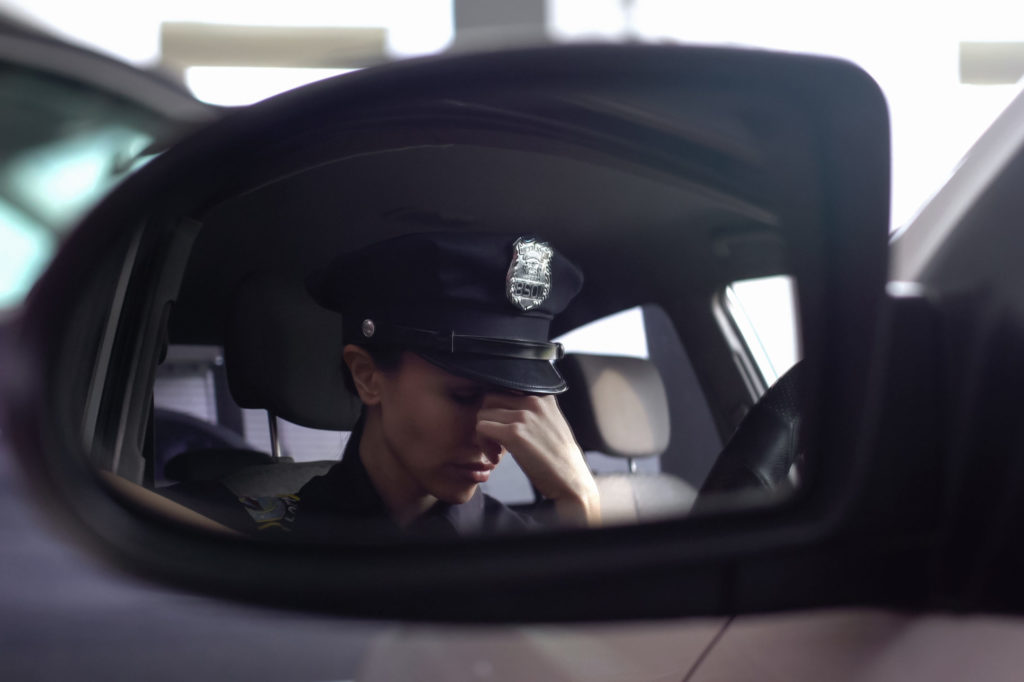 Fatigued officer in patrol car